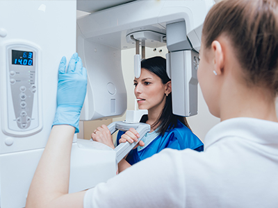 The image shows two individuals, likely professionals, engaged with advanced medical imaging equipment, possibly during a demonstration or educational session.